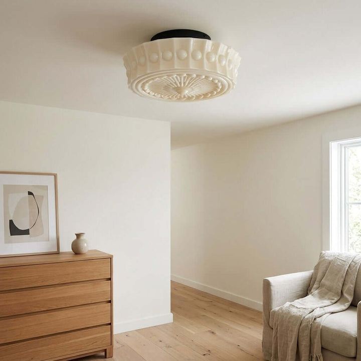 White patterned glass ceiling light with black metal mount in a minimalist sitting room