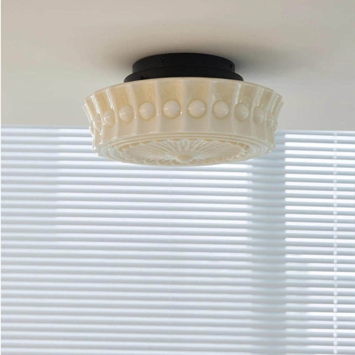 Side view of the creamy patterned milk glass shade mounted close to the ceiling