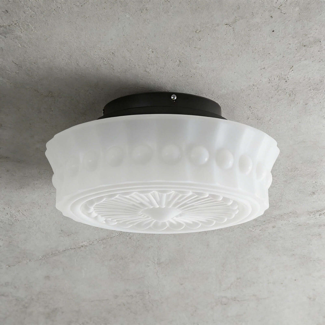 White vintage round ceiling light with patterned glass shade and black metal ceiling mount