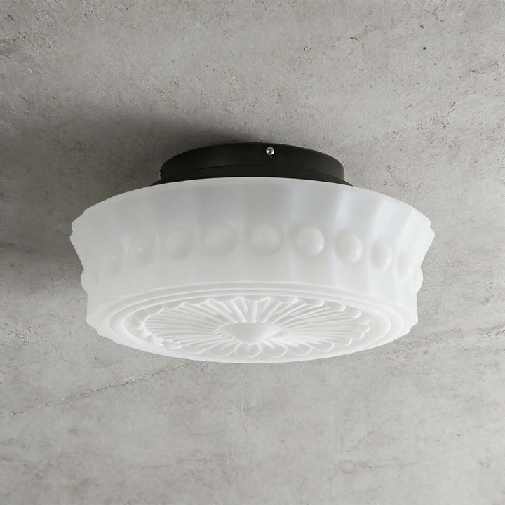 White vintage round ceiling light with patterned glass shade and black metal ceiling mount
