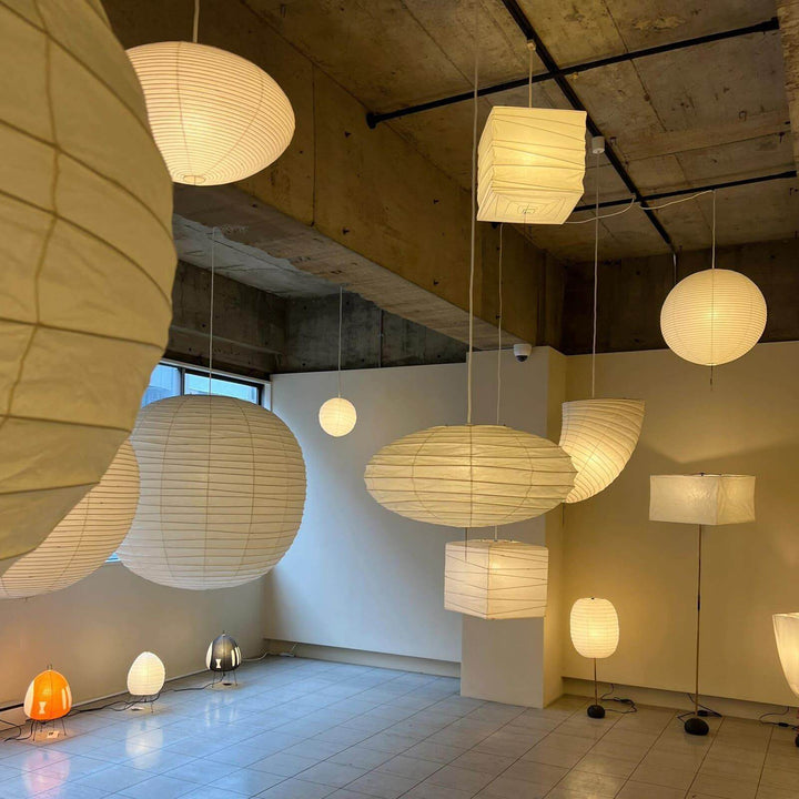 Washi paper pendant lights displayed in a lighting showroom.