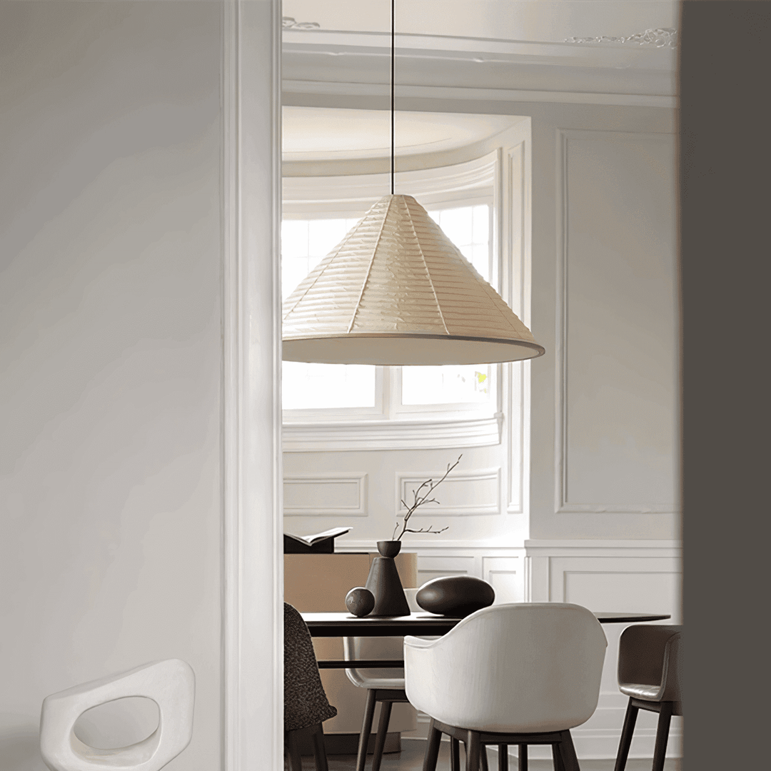 Large Washi paper pendant lamp above a dining table in a bright room with traditional wall molding