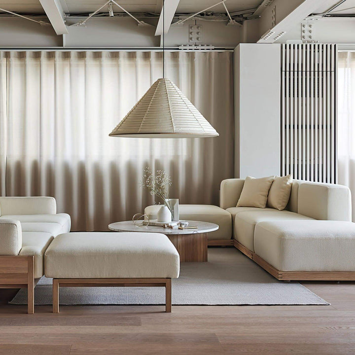 Large Washi paper pendant light above a round coffee table in a neutral Japandi living room