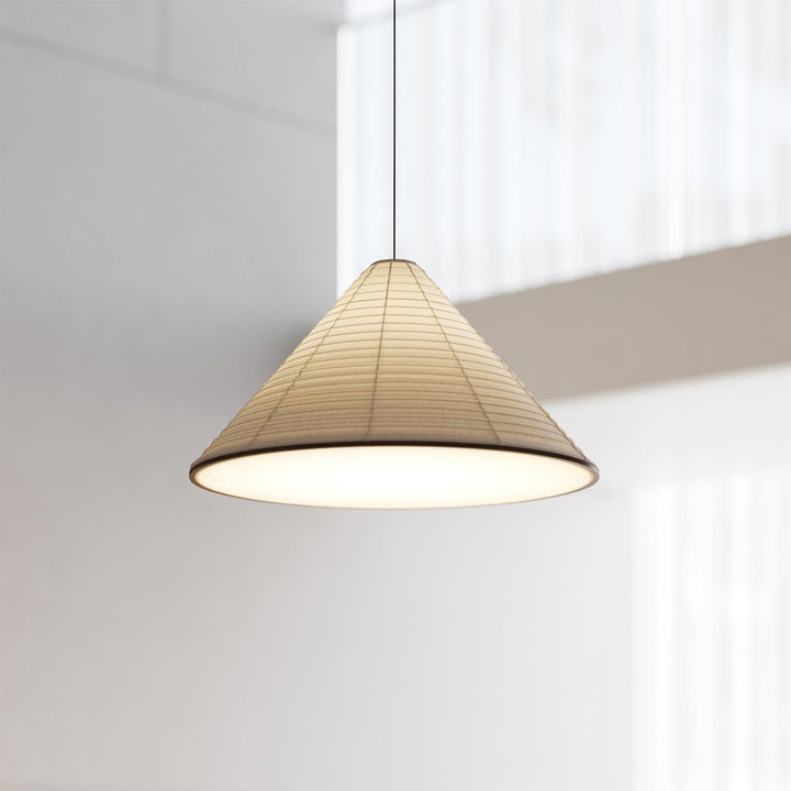 Illuminated Washi paper cone pendant light with a softly glowing bottom diffuser in a bright interior