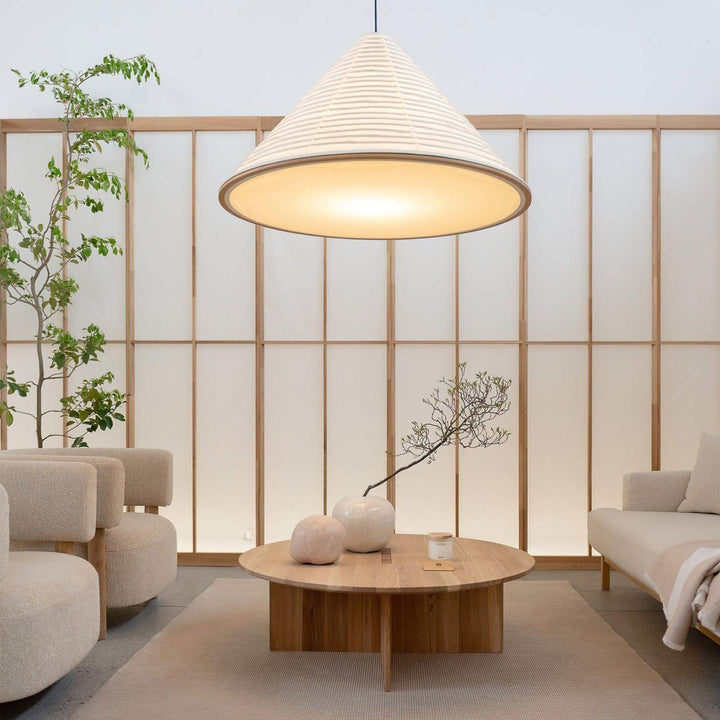 Oversized Washi paper pendant lighting above a round wood table in a serene Japandi lounge