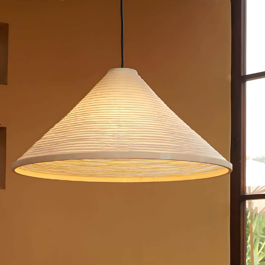 Close-up of the illuminated ribbed paper shade and circular lower diffuser on the Washi pendant lamp