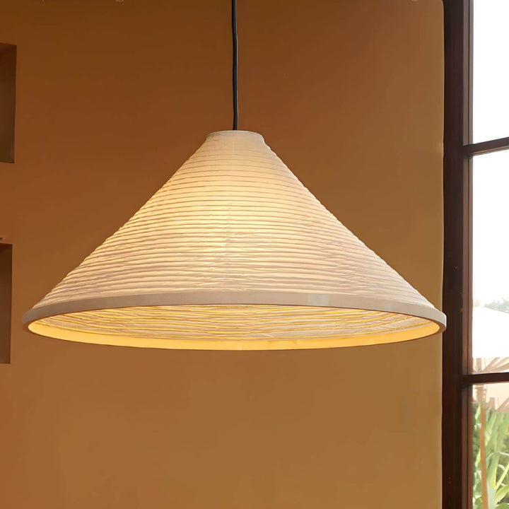 Close-up of the illuminated ribbed paper shade and circular lower diffuser on the Washi pendant lamp