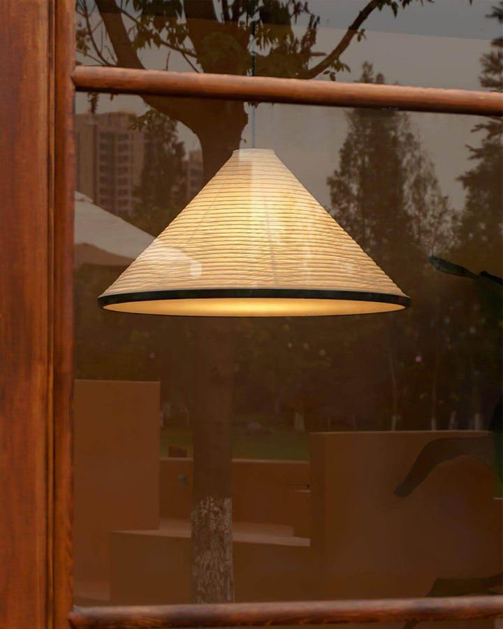 Illuminated Washi paper pendant light reflected in a wood-framed window during the evening