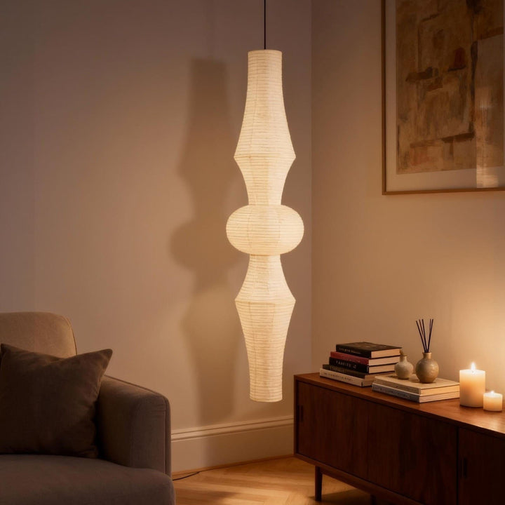 Washi paper pendant light suspended beside a clothing rail and floor mirror in a modern dressing room
