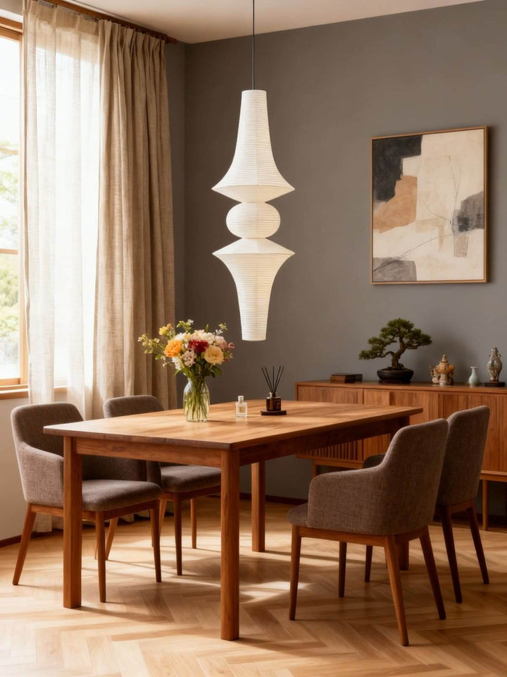 Washi paper pendant light creating a soft glow above a spacious double-height living room in the evening