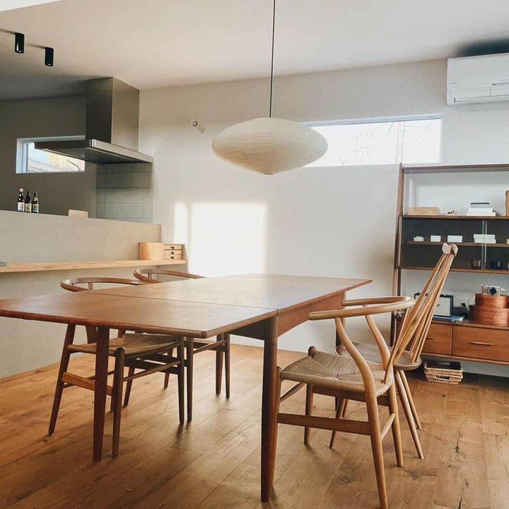 Washi paper pendant light above a kitchen dining table.