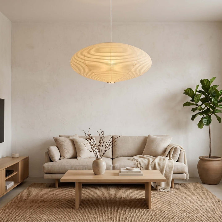 Oval washi paper pendant light over a sofa and coffee table.