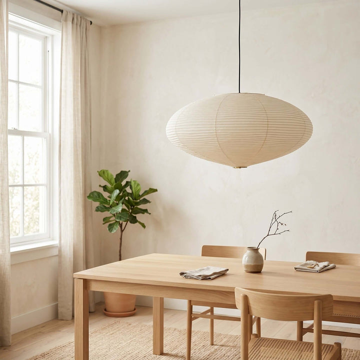 Minimal dining room with an oval washi paper pendant light.