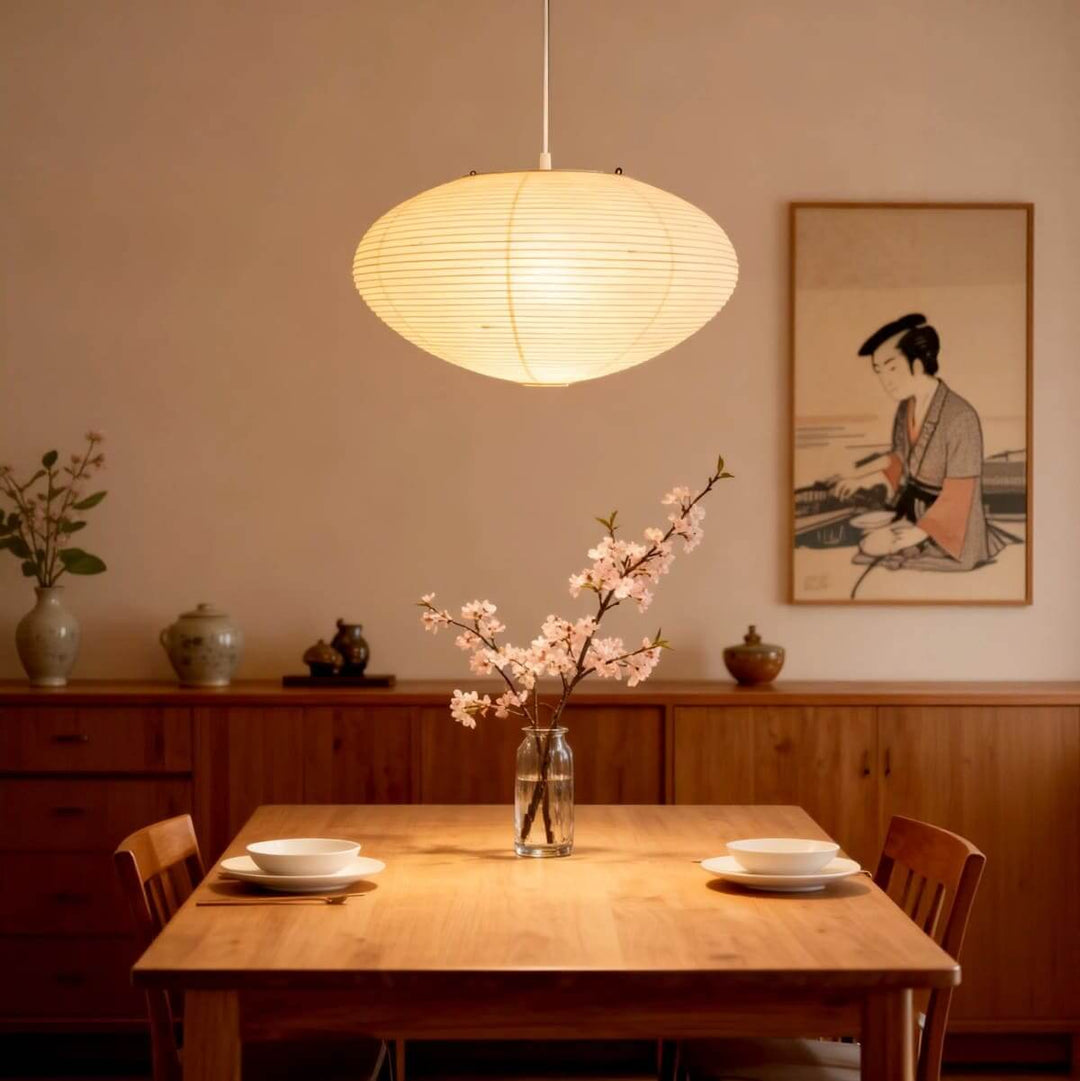 Glowing washi paper pendant light above a warm wood dining table.