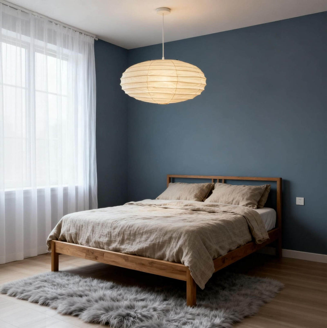 White cord washi paper pendant light in a bedroom with a blue accent wall.