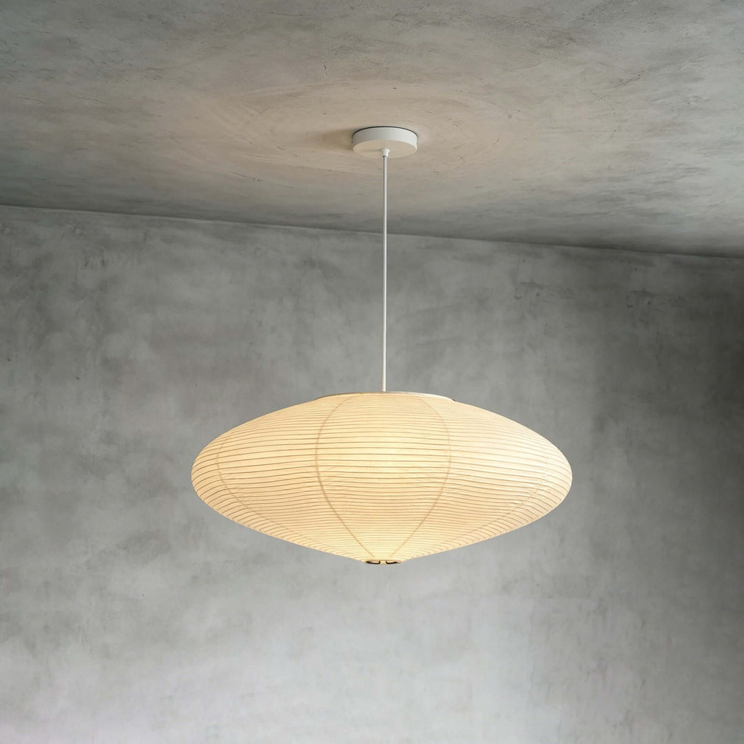White cord washi paper pendant light mounted against a gray wall.
