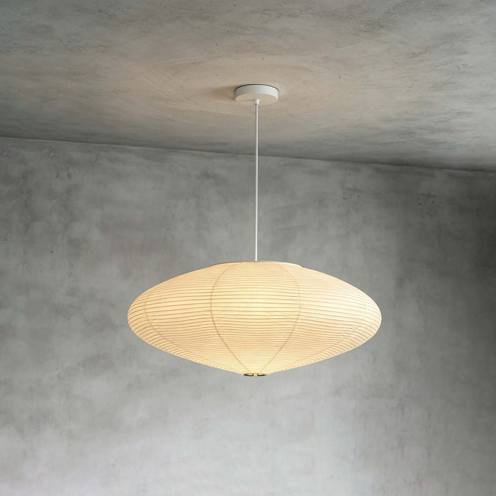 White cord washi paper pendant light mounted against a gray wall.