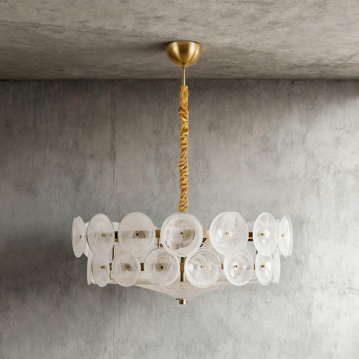 White glass disc chandelier with a brass-tone frame and adjustable hanging chain