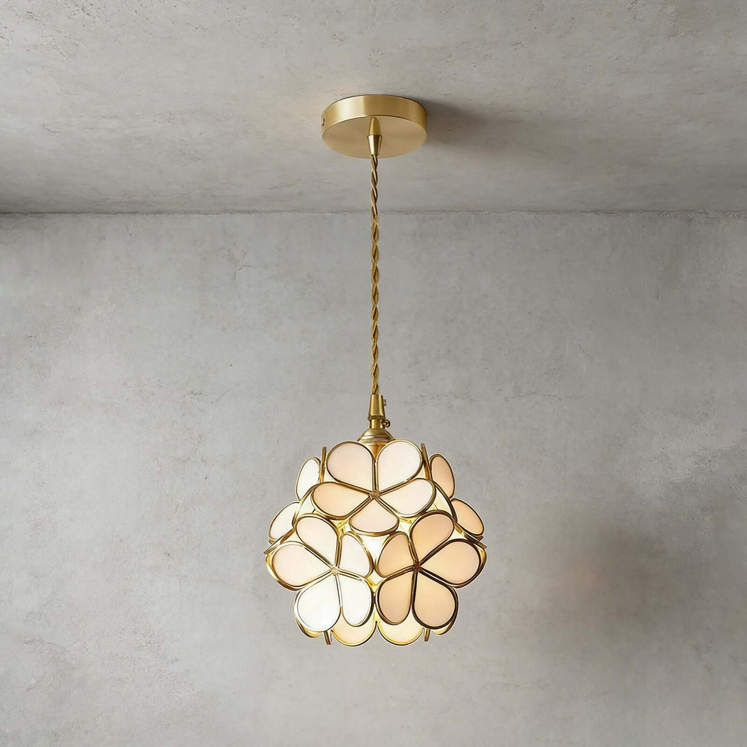 White glass petal pendant light installed against a textured concrete wall