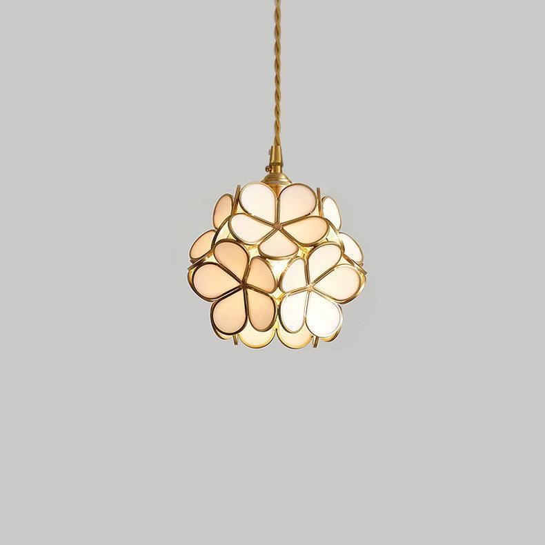 White stained glass petal pendant light with rounded floral panels and brass suspension