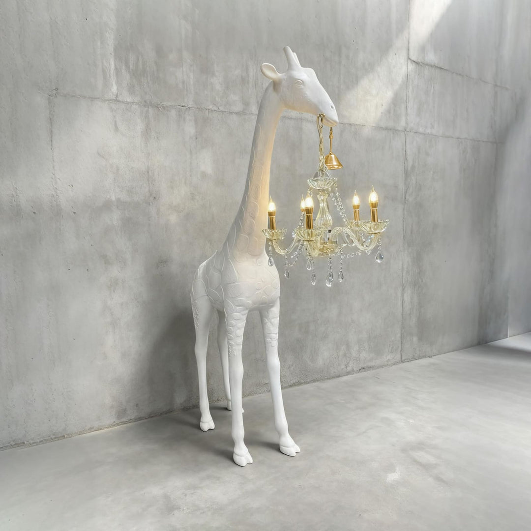 White resin giraffe floor lamp with gold hardware and an illuminated crystal light