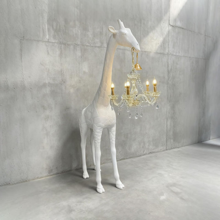 White resin giraffe floor lamp with gold hardware and an illuminated crystal light
