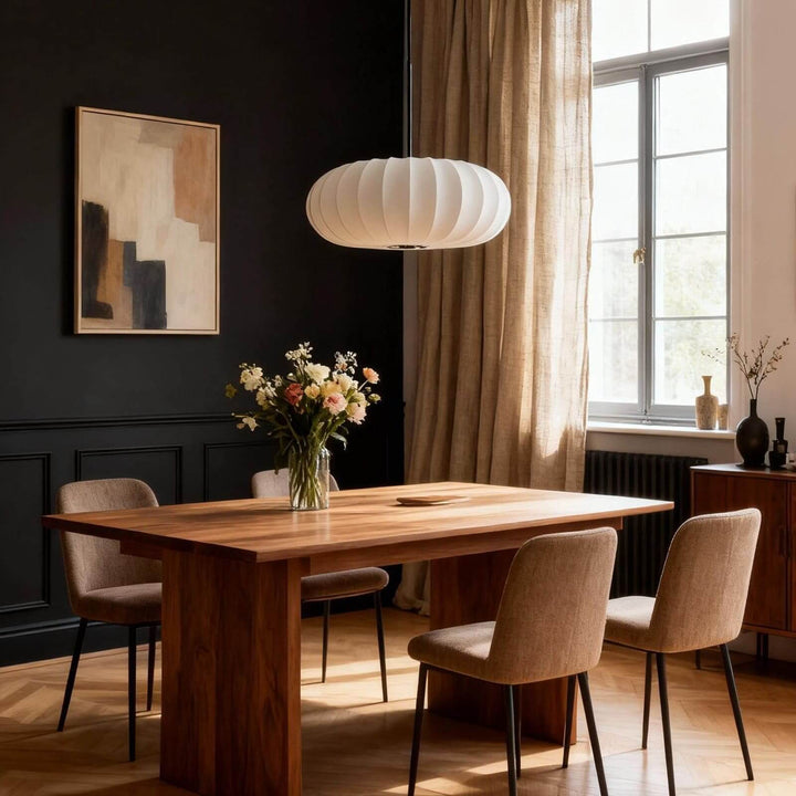 White Verona pendant light above a dining table against a black accent wall