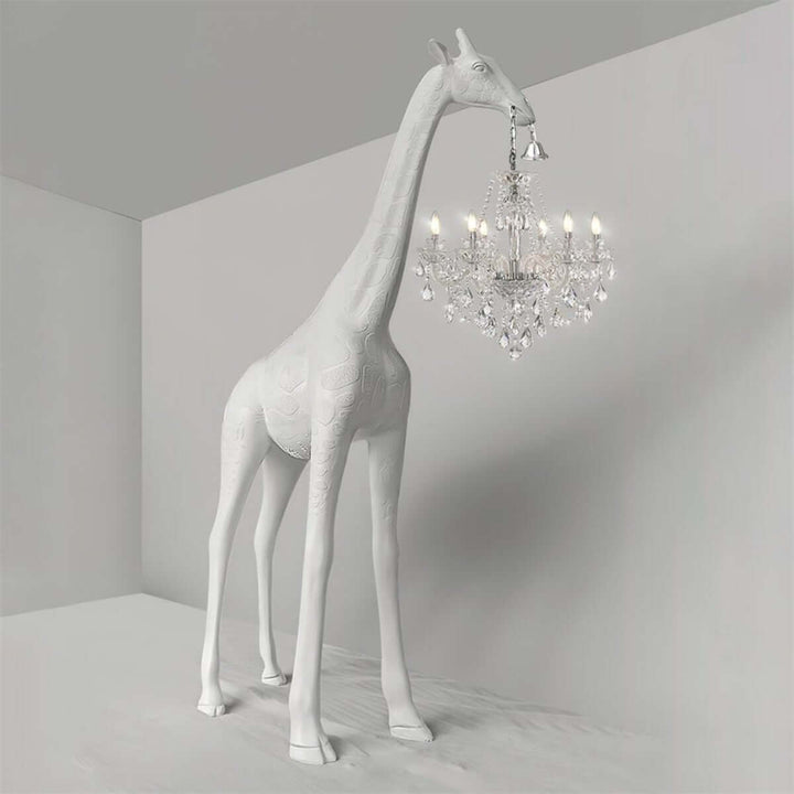 Sculptural white giraffe floor lamp holding a silver crystal chandelier