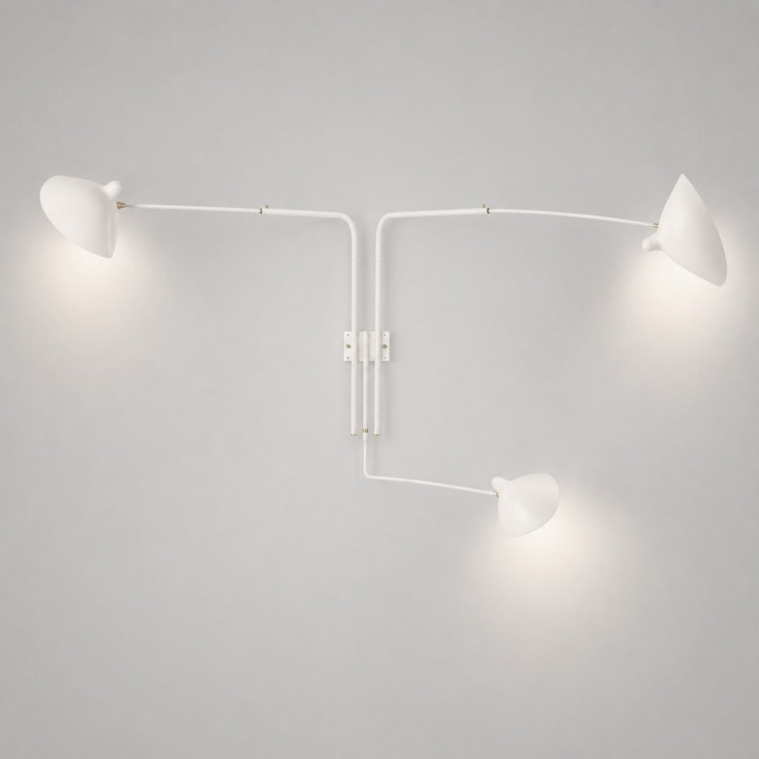 White three-light wall sconce with long adjustable arms and directional cone shades