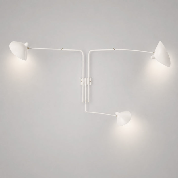 White three-light wall sconce with long adjustable arms and directional cone shades