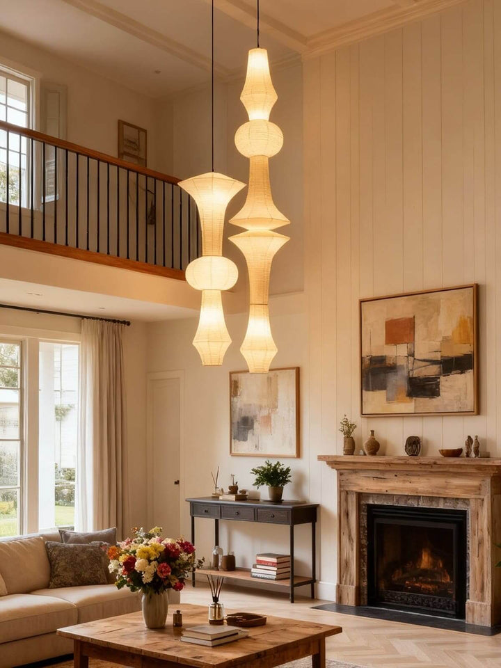 White Washi paper pendant light centered above a wood dining table in a warm modern dining room