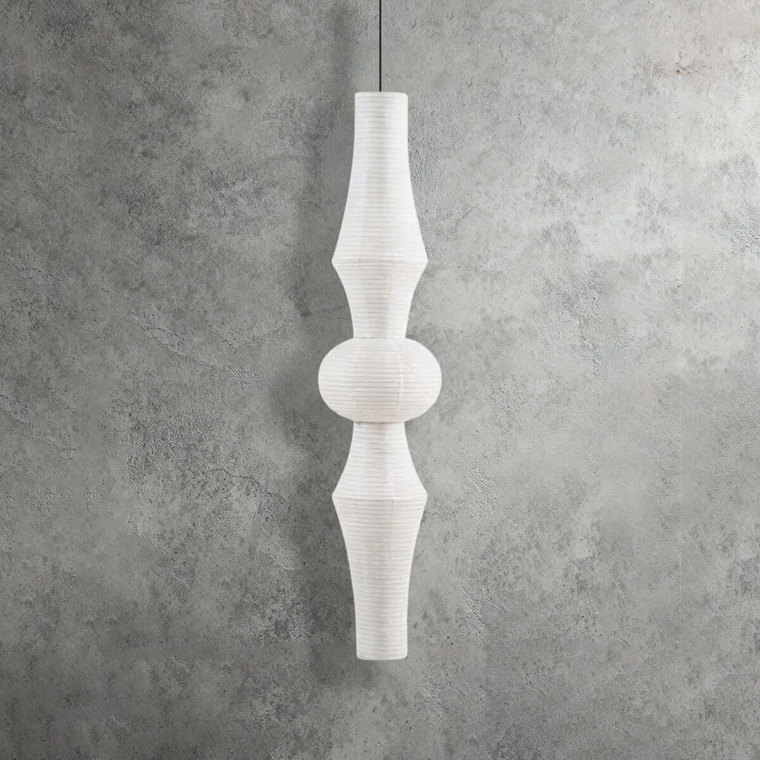 Extra-tall white Washi paper pendant light with an elongated layered silhouette on a textured gray background