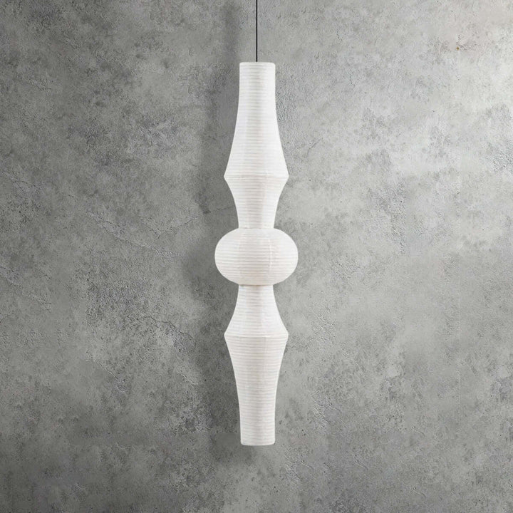 Extra-tall white Washi paper pendant light with an elongated layered silhouette on a textured gray background