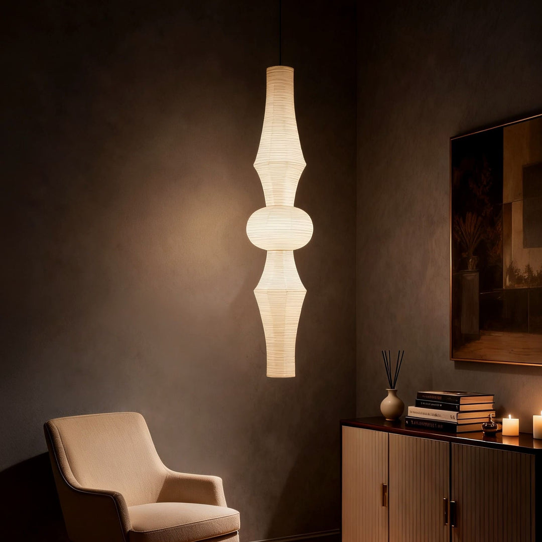 Unlit white Washi paper pendant light with a ribbed sculptural shade against a textured gray background