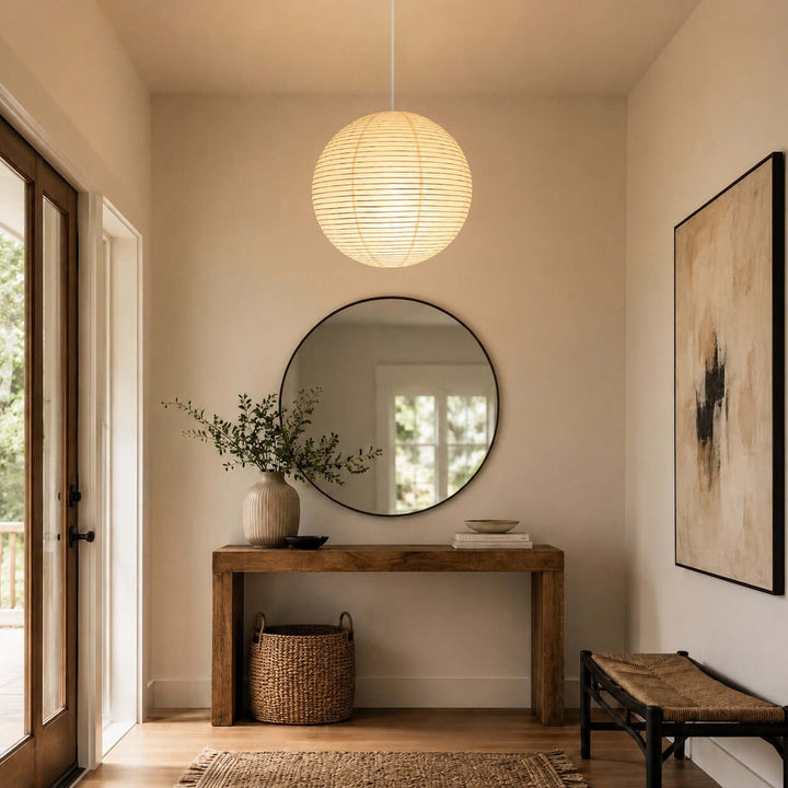 Rice paper entryway pendant light with a white wire above a console table