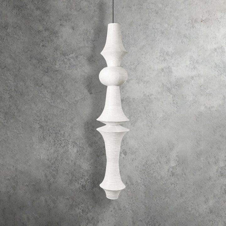 Yellowish Washi paper pendant light with a narrow geometric top, rounded center and tapered lower shade