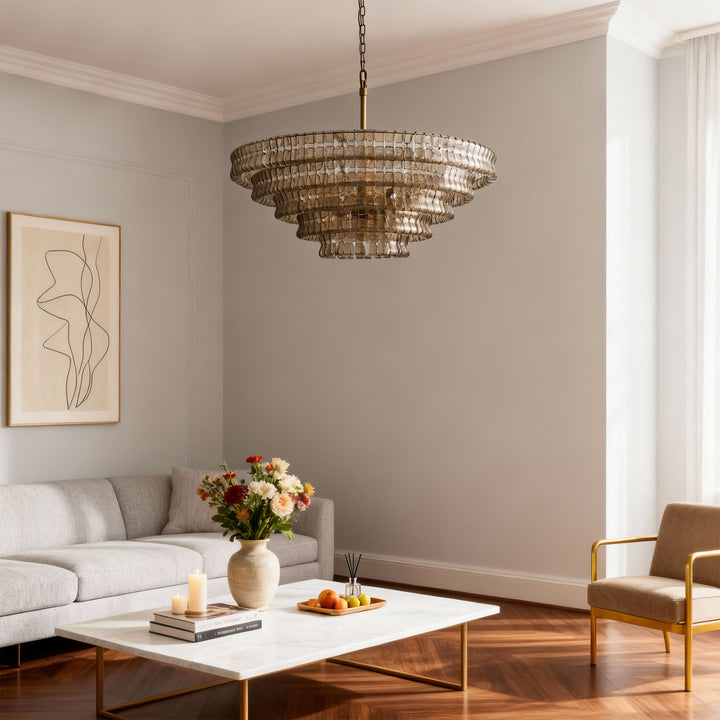 Smoky tiered glass chandelier hanging over a coffee table in a bright room with a gray sofa