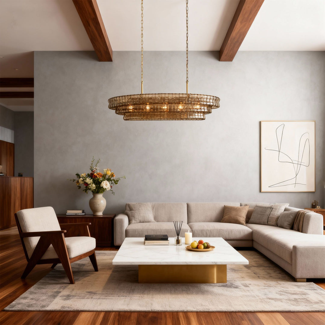 Linear smoky glass chandelier above a modern living room with exposed beams and sofa