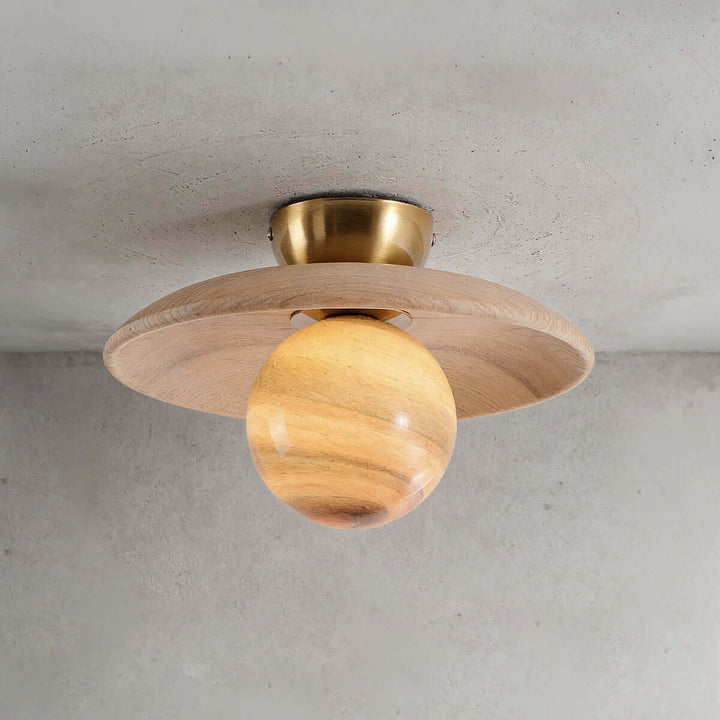 Close-up of the beige Zolira ceiling lamp with a light wood canopy and amber glass globe
