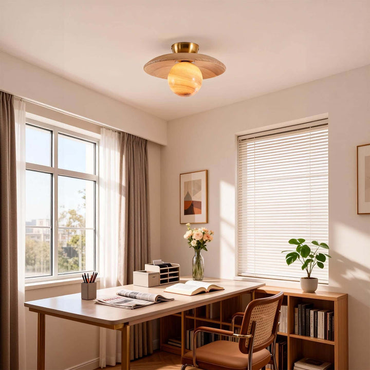 Beige Zolira ceiling lamp above a wood desk in a bright office with large windows