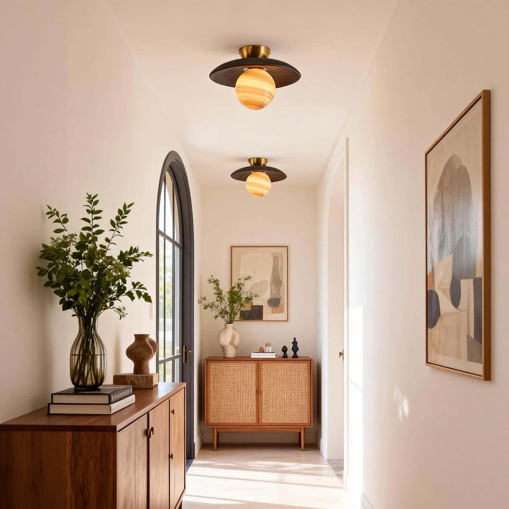 Two brown Zolira ceiling lights installed along a bright hallway with arched windows