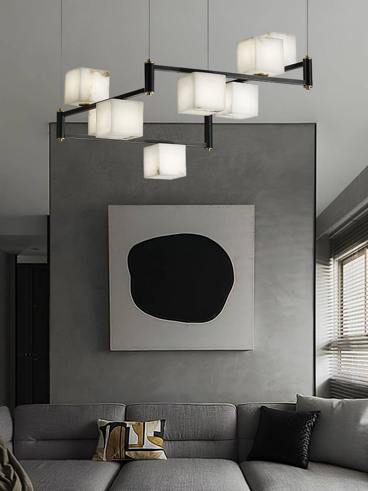 Elegant mid century modern alabaster chandelier hanging above a stylish gray sofa in a contemporary living room.