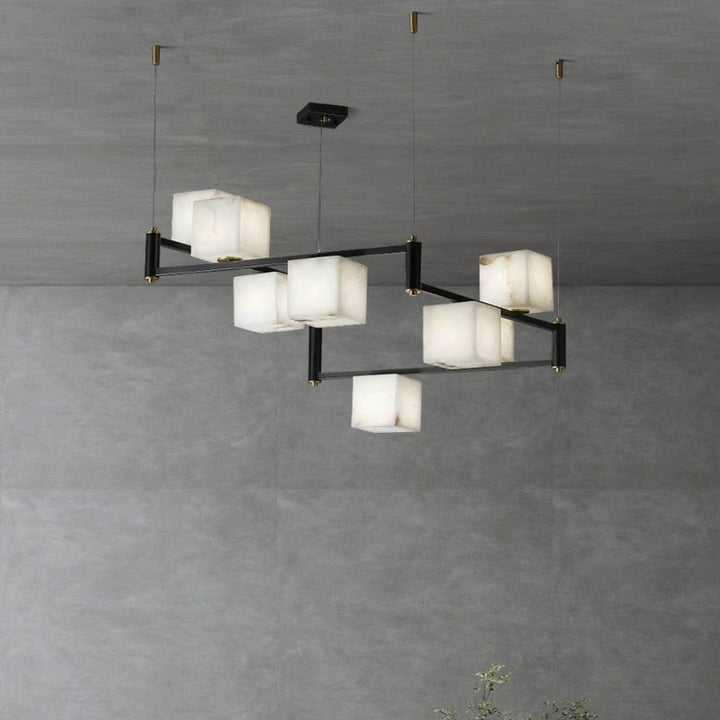 Stunning mid century modern alabaster chandelier with a sleek metal frame and multiple square shades.