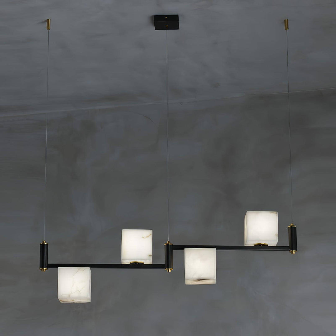 Mid century modern alabaster square box chandelier with black accents and four lights against a gray background.