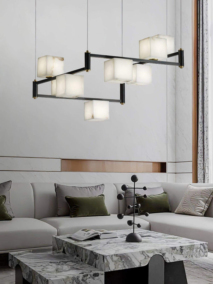 Stylish mid century modern alabaster chandelier hanging above a chic marble coffee table in a contemporary living room.