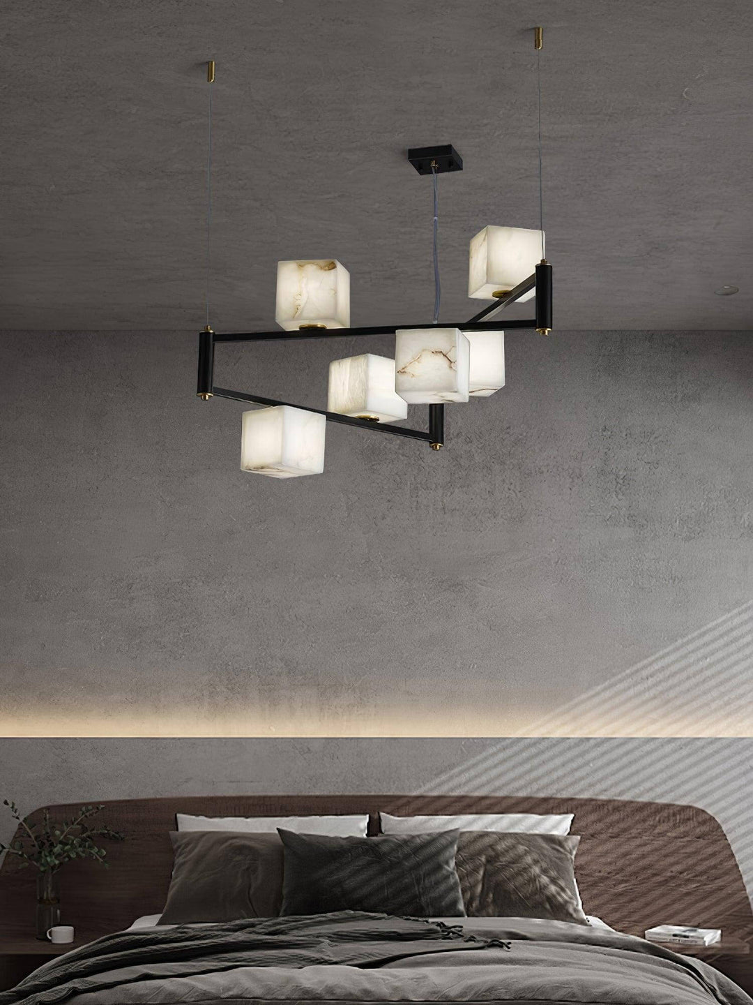 Mid century modern alabaster chandelier with five floating cubes above a contemporary bedroom.